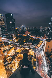 person sitting on top of building thumbnail