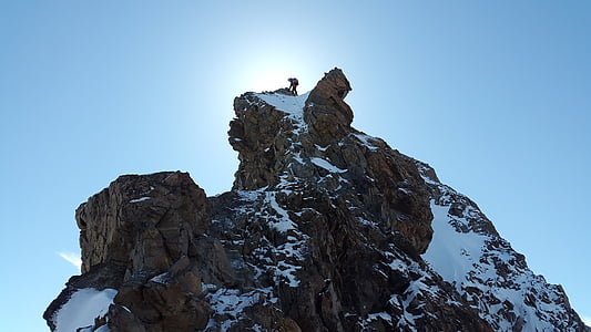 man on top of snow covered mountain thumbnail