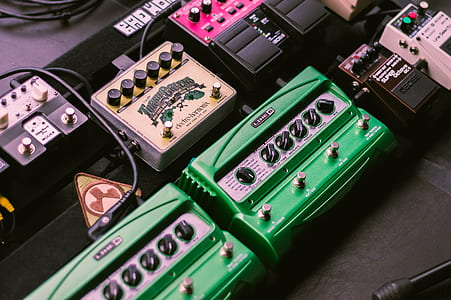 black and green guitar pedals on black surface thumbnail