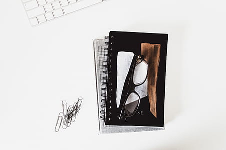 black framed eyeglasses on book thumbnail
