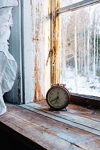 double bell alarm clock near glass window thumbnail