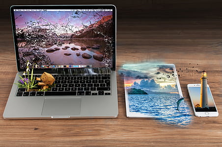 silver MacBook, white iPad and iPhone 6 on the wooden panel thumbnail