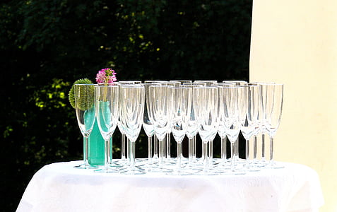 clear flute glasses on table at daytime thumbnail