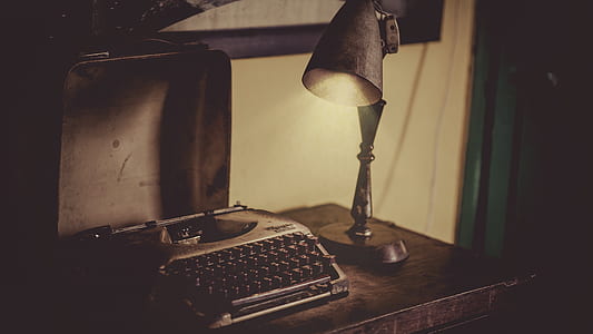 Sephia Photography of Desk Lamp Lightened the Gray Typewriter on Wooden Table thumbnail