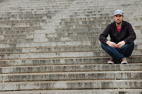man sitting on gray stair thumbnail