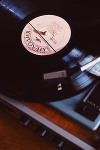 black vinyl record near brown wooden surface thumbnail