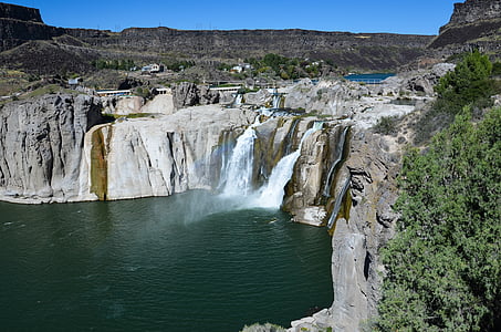 waterfalls under blue sky during daytime thumbnail