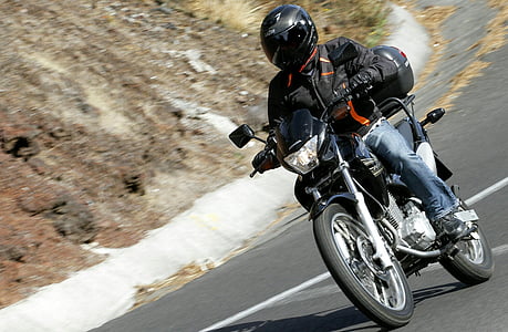 selective focus photo of man riding standard motorcycle thumbnail