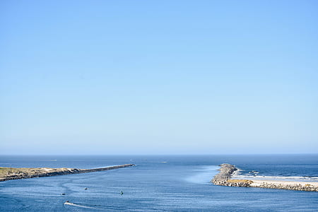 body of water under blue sky during daytime photo thumbnail