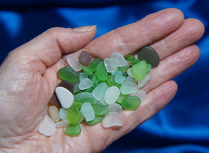 person holding green and white stones thumbnail