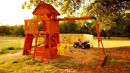 red all-terrain vehicle parked beside outdoor playset thumbnail