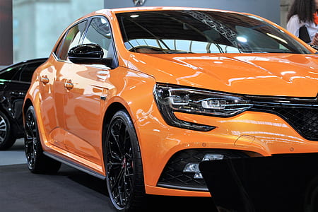 orange Renault sedan parked in showroom thumbnail