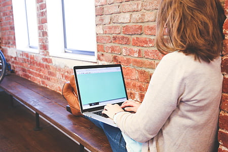 woman sitting while using laptop thumbnail