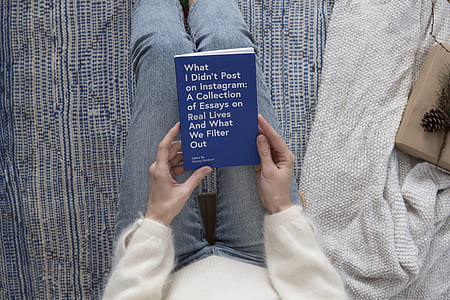person holding blue and white title book thumbnail