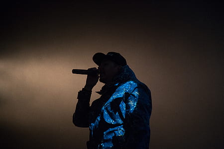 man holding mic in front of his mouth thumbnail