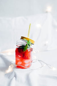 clear glass mason jar on white textile thumbnail