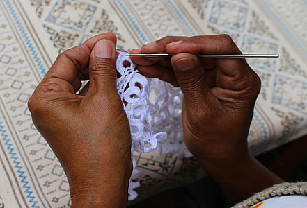 photo of person knitting floral lace textile thumbnail