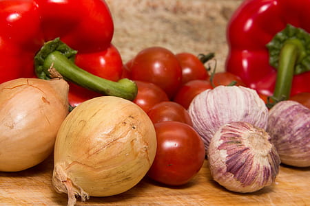white onions, red bell peppers, and tomatoes on brown wooden surface thumbnail