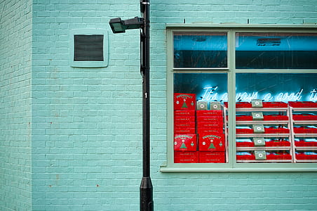 brown post lamp in front of white concrete building thumbnail