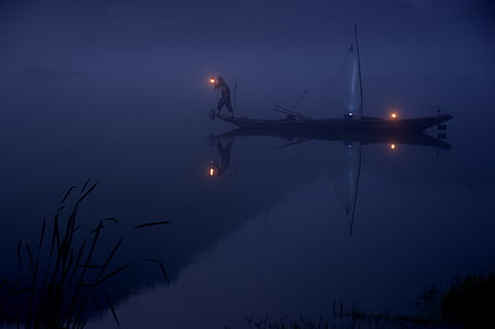 boat on body of water at night thumbnail