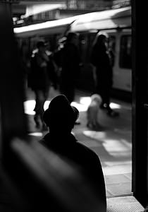 greyscale photography of people walking on train station thumbnail