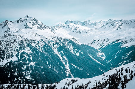 aerial photography of ice-capped mountain under blue sky thumbnail