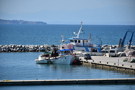 white yacht on dock during daytime thumbnail