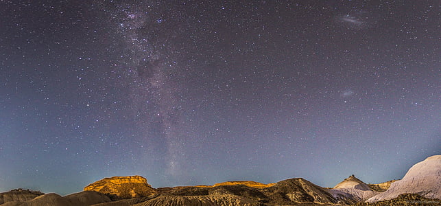 brown mountains under starry sky thumbnail