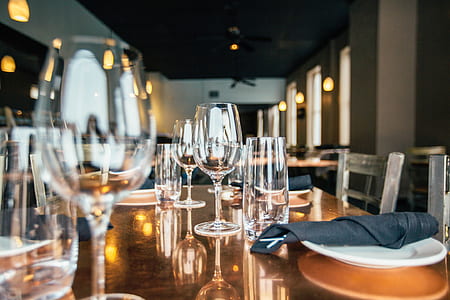 selective focus photography of wine glasses placed on table thumbnail