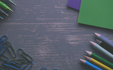 assorted-color pencils near cardboards thumbnail