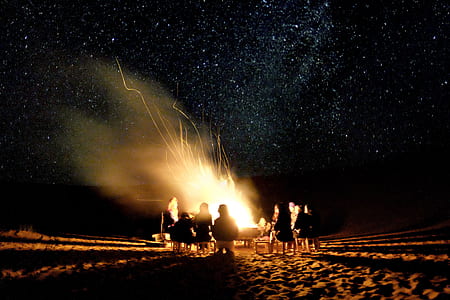 silhouette of people in front of bonfire thumbnail