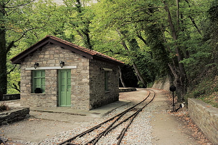 brown concrete house near railway thumbnail