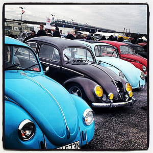 four assorted-color Volkswagen Beetle coupes photo thumbnail