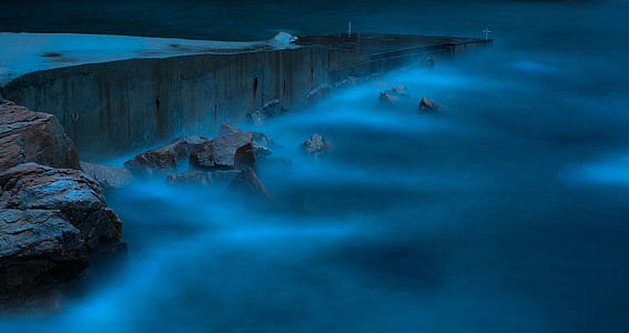 cliff covered by fog during nighttime thumbnail