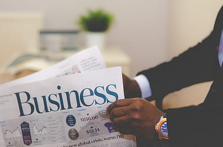 person holding Business newspaper thumbnail