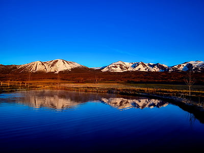 calm body of water under blue sky thumbnail