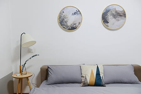 Beige Wooden Nightstand With White Desk Lamp; Brown Wooden Bed With Grey Comforter Set thumbnail