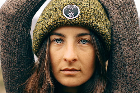 closeup photo of woman wearing brown sweater thumbnail