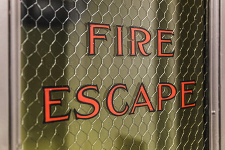 Close up of Fire Escape written on the glass pane of a door thumbnail
