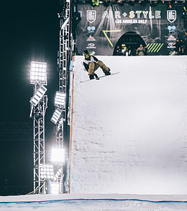 person doing trick on mid-air by using snowboard thumbnail