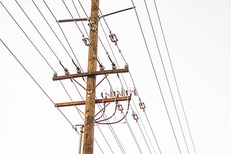 brown and gray electric pylons under gray sky thumbnail