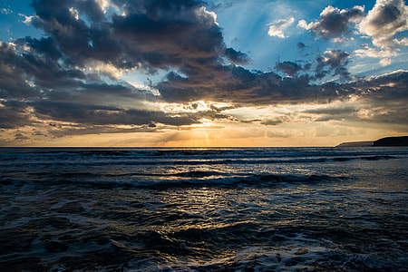 body of water under cloudy sky thumbnail