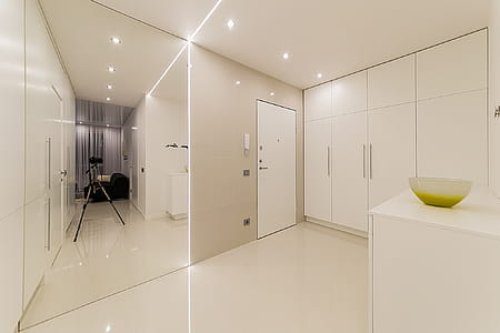 White Wooden Cabinet Beside White Wooden Door thumbnail