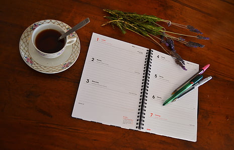white notebook beside ceramic teacup thumbnail