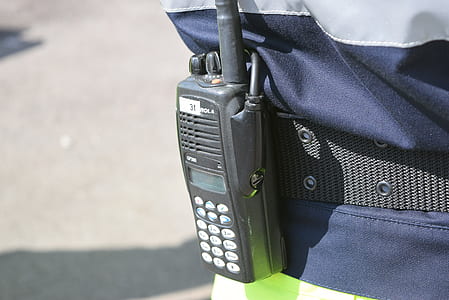 person wearing gray two-way radio at daytime thumbnail