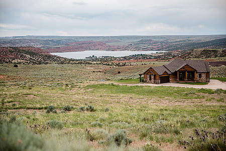 brown building near body of water thumbnail