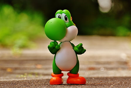 Yoshi plastic figure on brown surface thumbnail