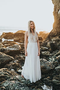 woman in white dress standing on boulder thumbnail