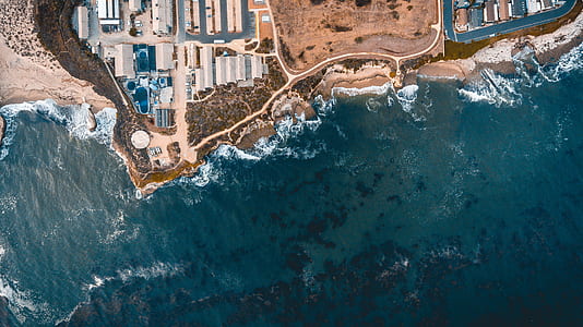 aerial photo of buildings near body of water thumbnail