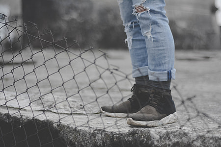 person standing on gray pavement thumbnail